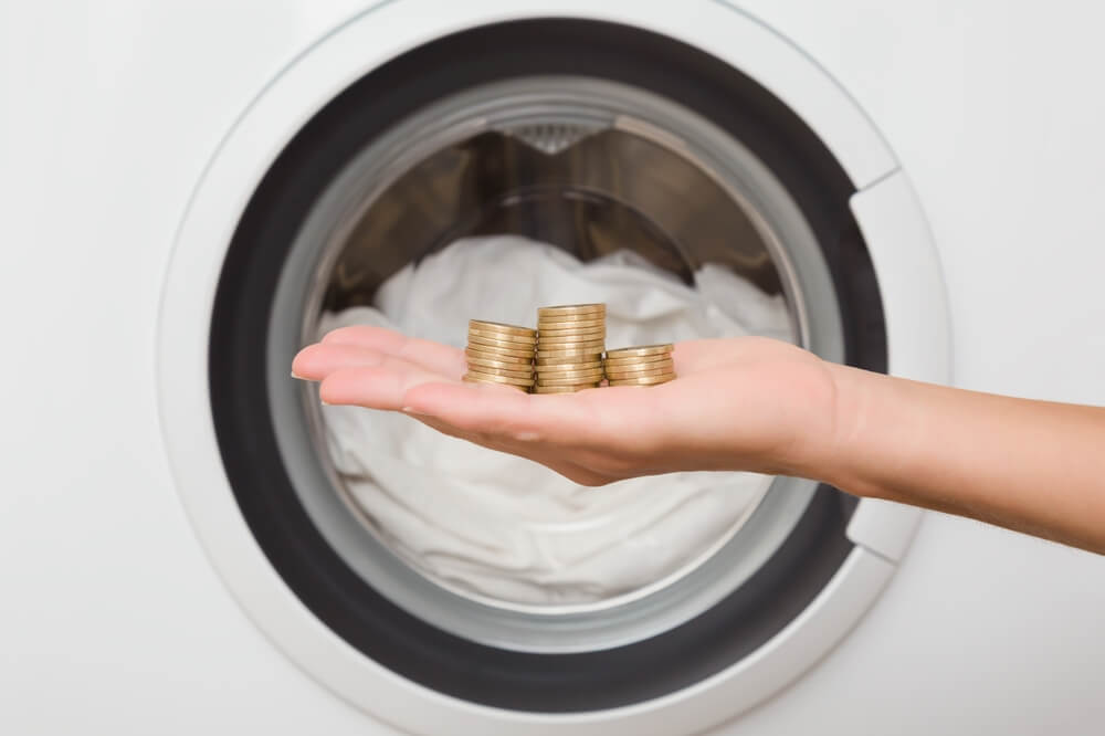 laundry washing machine with hand show on coin to save really cost