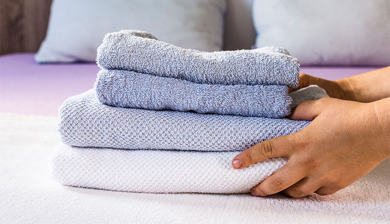 Washing complete: A person stacks freshly laundered towels